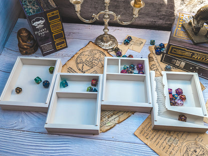 a table topped with lots of boxes filled with dice